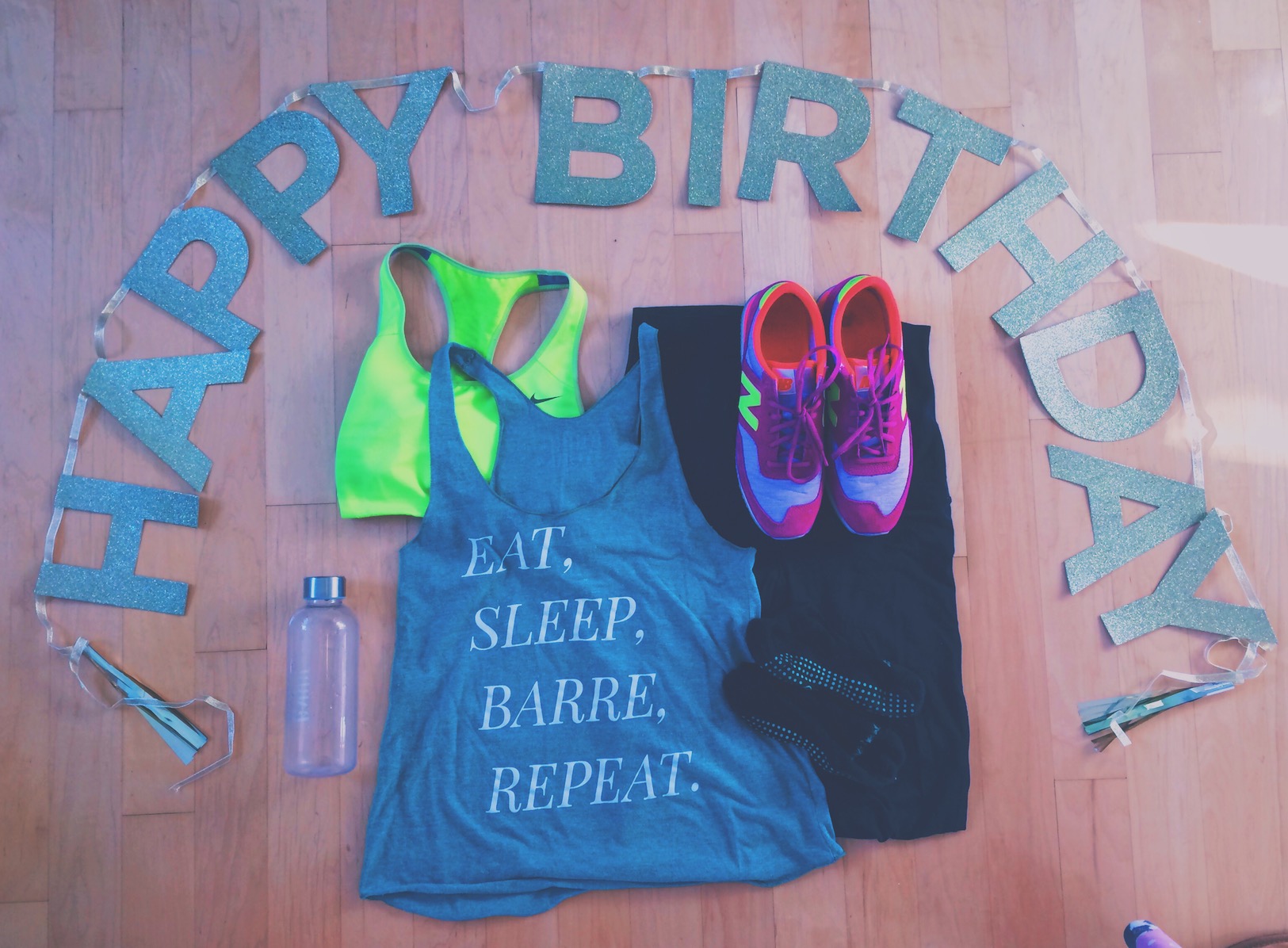 An image of clothes on the floor with a happy birthday sign.