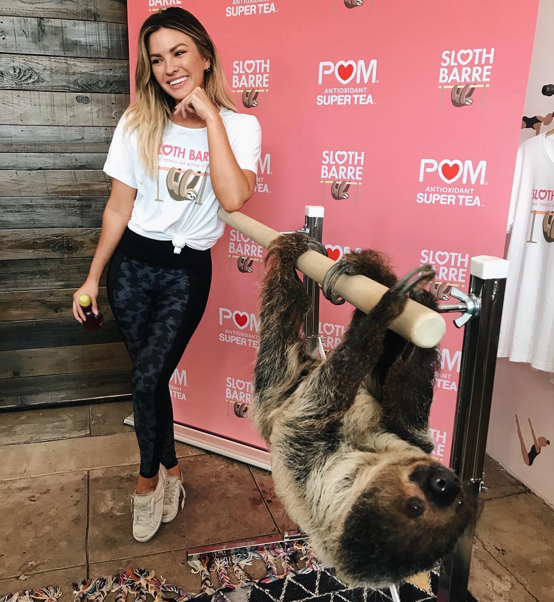 Becca Tilley poses with a sloth during sloth barre at Barre Belle in Los Angeles.