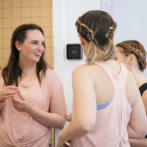 Three women socialize at a birthday barre-ty