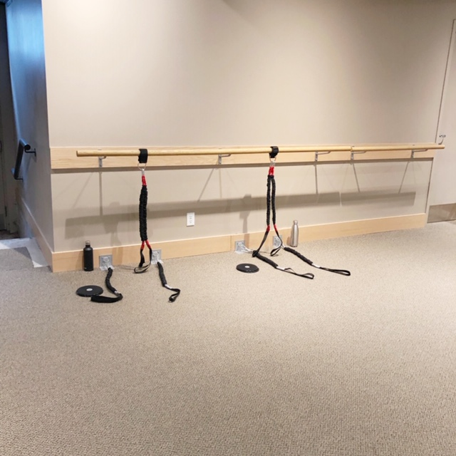 Resistance bands hang from the barre at Pure Barre before a Pure Reform class.