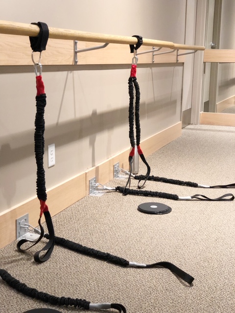Resistance bands hang from the barre at Pure Barre before a Pure Reform class.