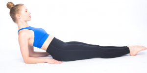 A woman doing a reverse forearm plank