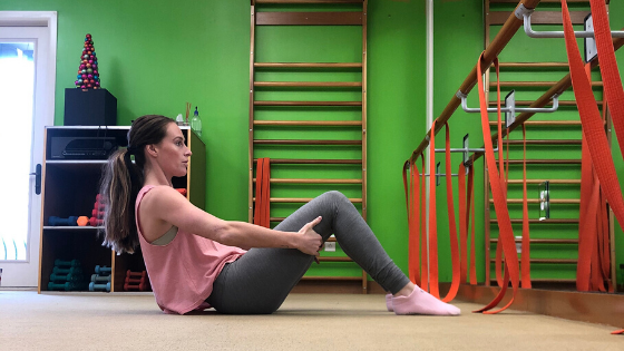 A woman demonstrates the high c-curve position at the barre