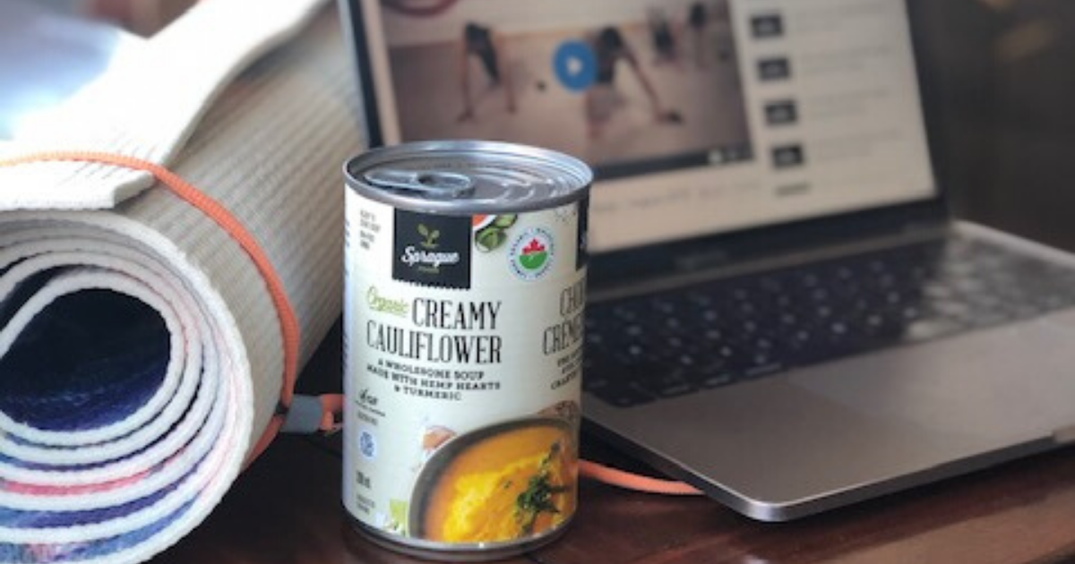 Yoga mat, soup can and laptop computer grouped together on a table