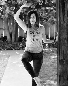 HIIT Barre Turlock's Ashleigh Volk does a barre pose, while posing for the camera.
