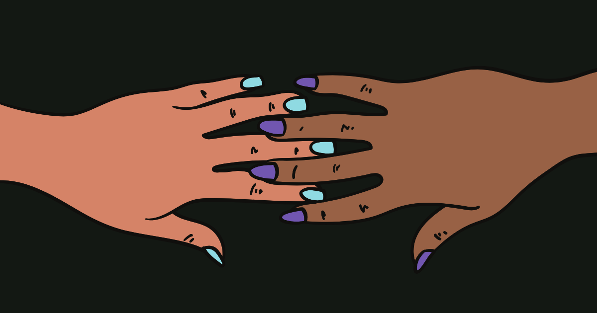 A white and brown hand touching each other