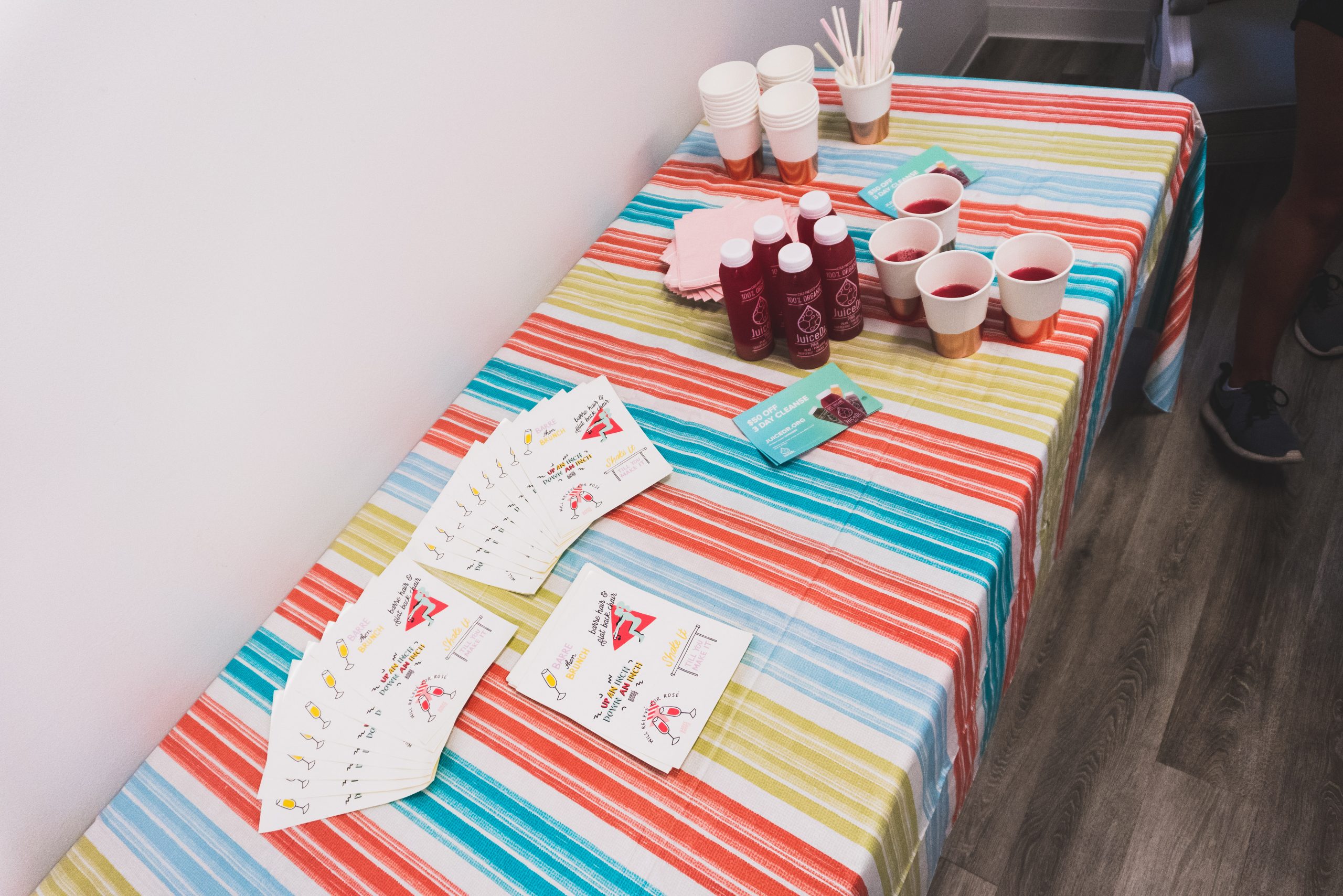 Stickers and juice are displayed on a table at The Bar Method's Wayne, Pennsylvania location.