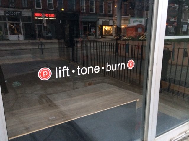 Signage in the window of Pure Barre Queen street west in Toronto.