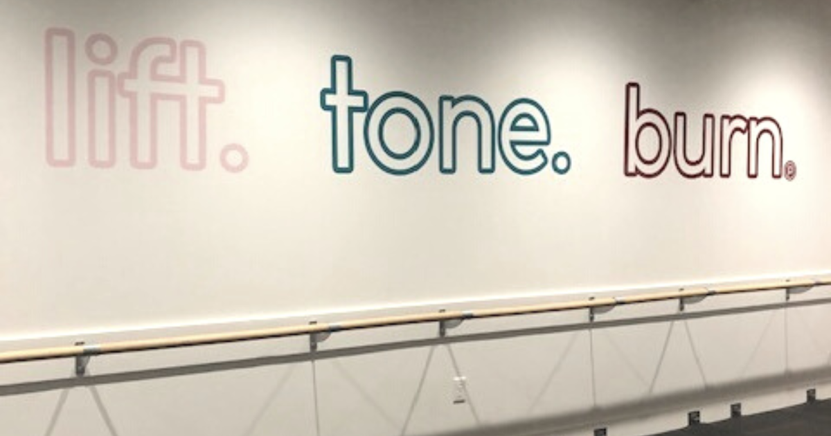 A lift tone burn mural on the wall of Pure Barre Winter Garden